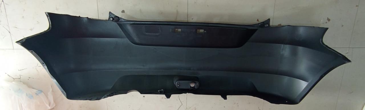 Maruti Suzuki rear bumper part model 71811M74L00, black plastic bumper with mounting brackets for rear of vehicle