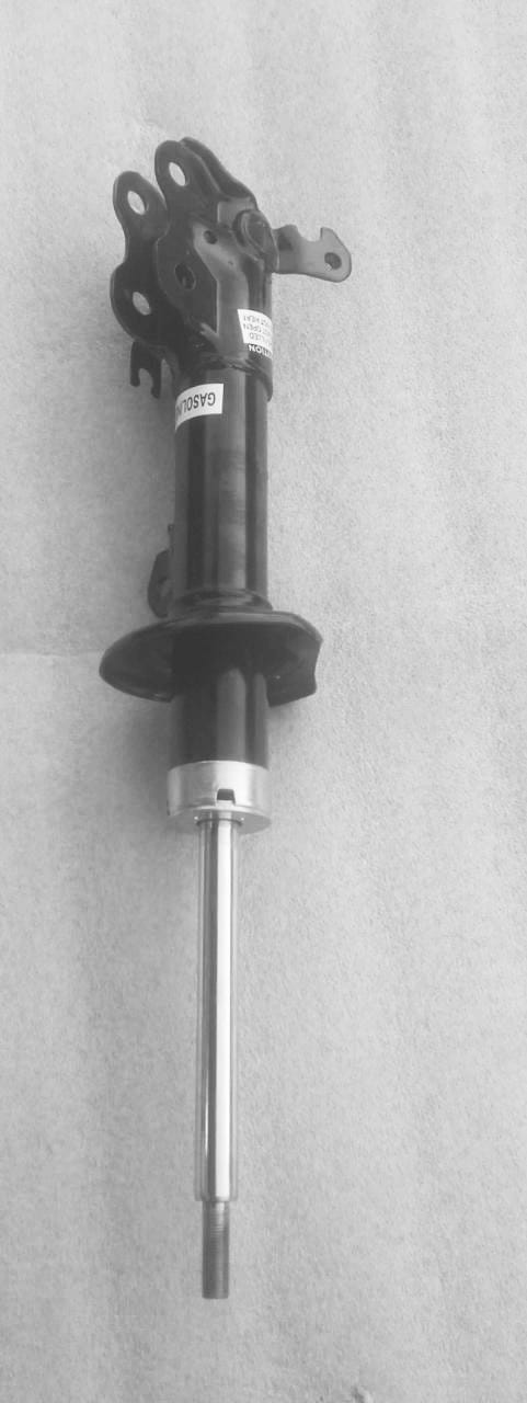 Maruti Suzuki front right suspension strut assembly showing the shock absorber and mounting components.
