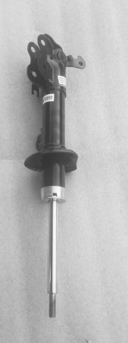Maruti Suzuki front right suspension strut assembly showing the shock absorber and mounting components.