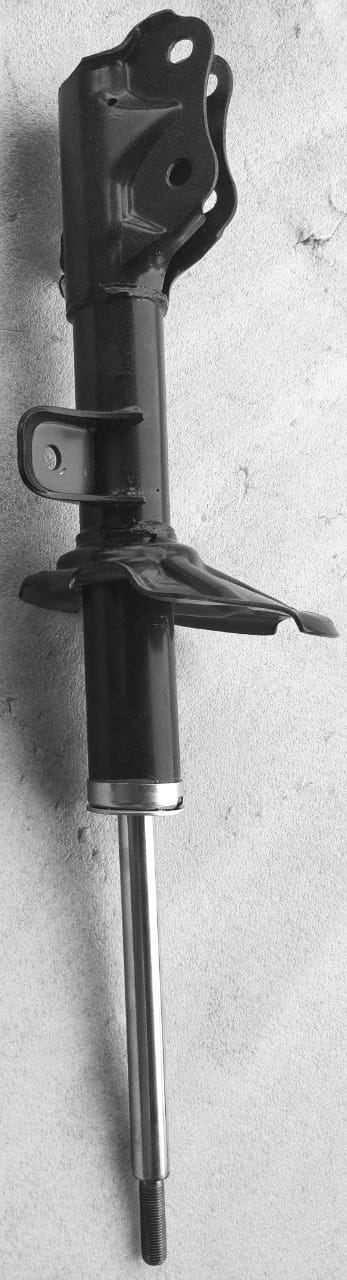 Front strut assembly for Maruti Suzuki vehicle, part number 41602M76M00, showing the new suspension component installed.