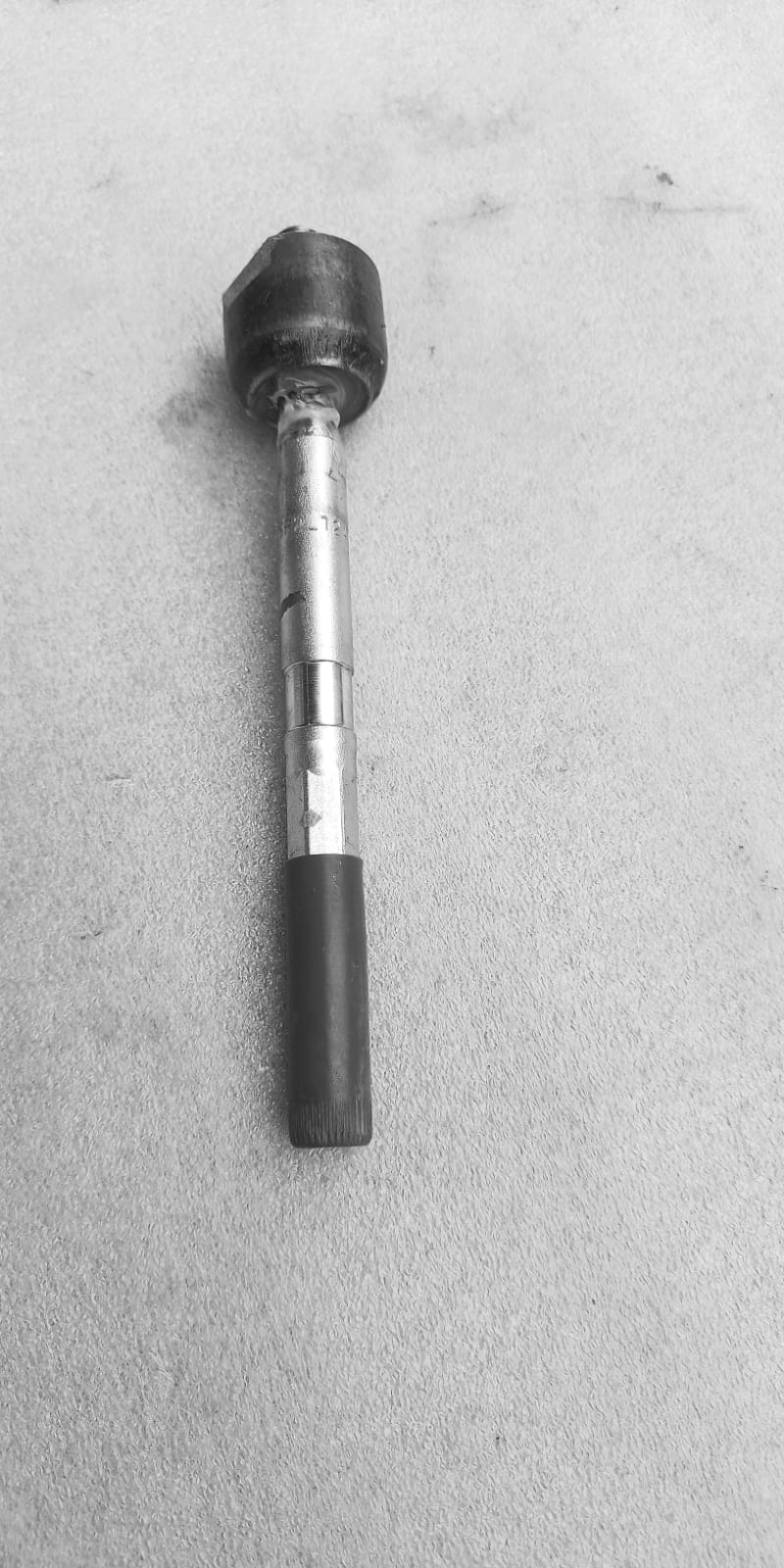 Maruti Suzuki tie rod 48830M74L10 showing a close-up of the steering component for vehicle suspension and steering system.
