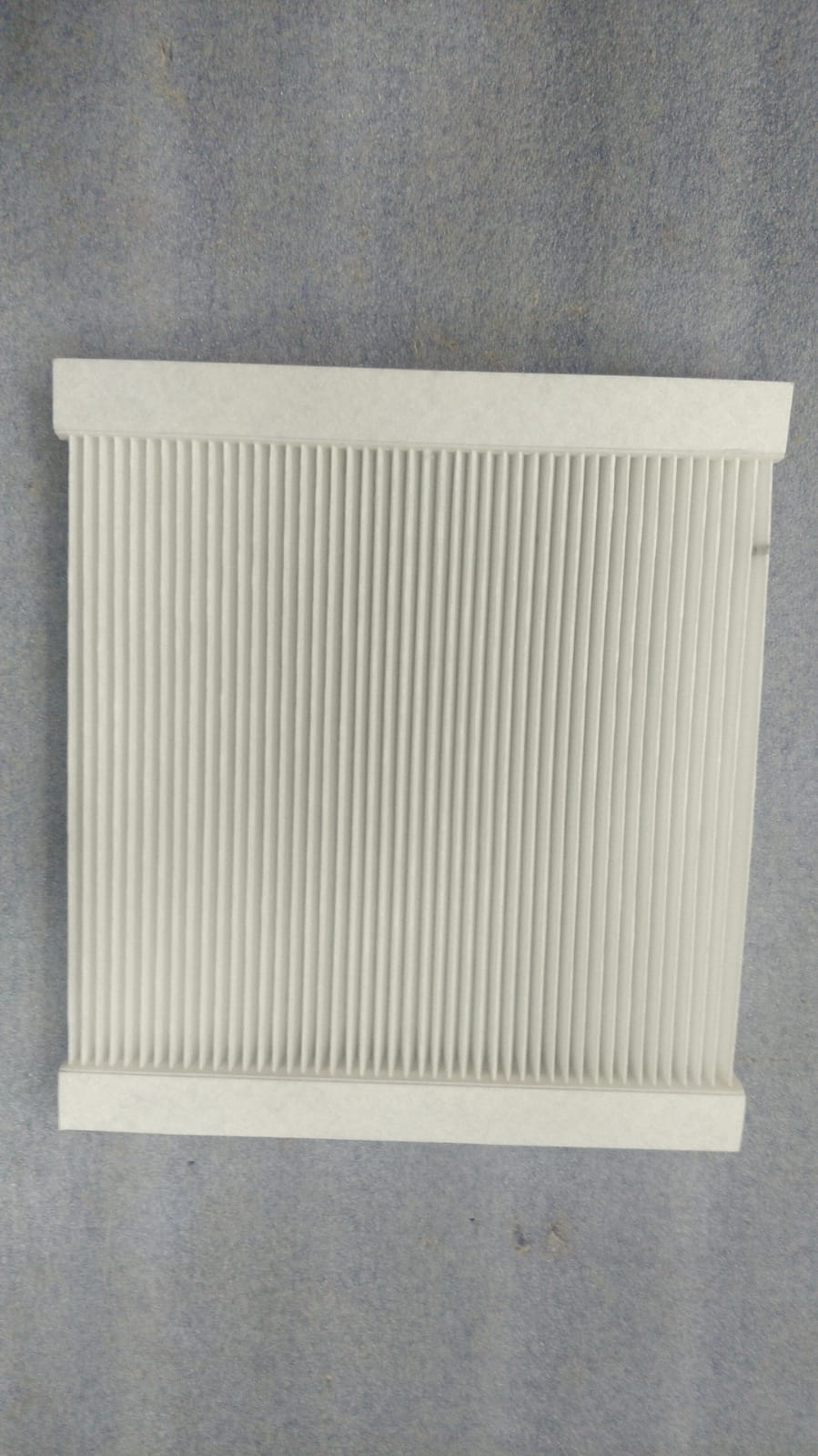 Minda AC filter duster, model CF7044, showing the clean, rectangular filter with pleated surface for air purification.