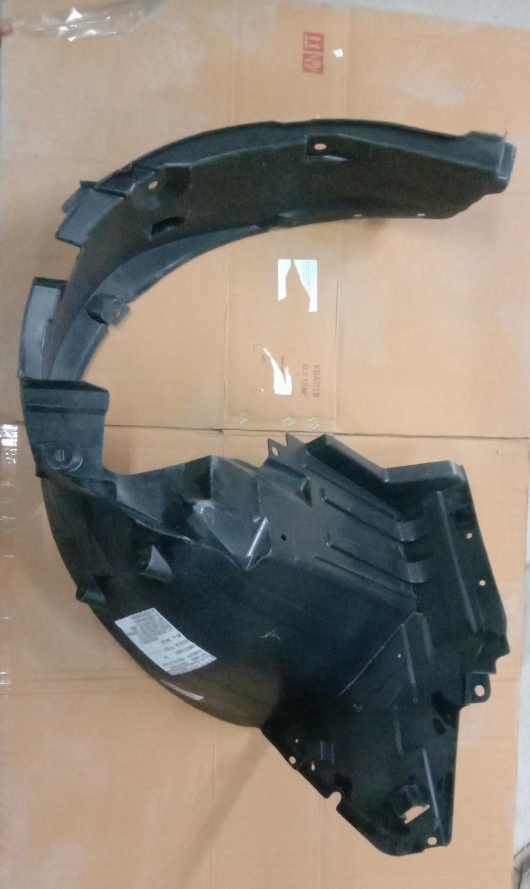 Right front fender lining for Nissan Micra, genuine Nissan part, showing the black plastic guard installed on the vehicle.
