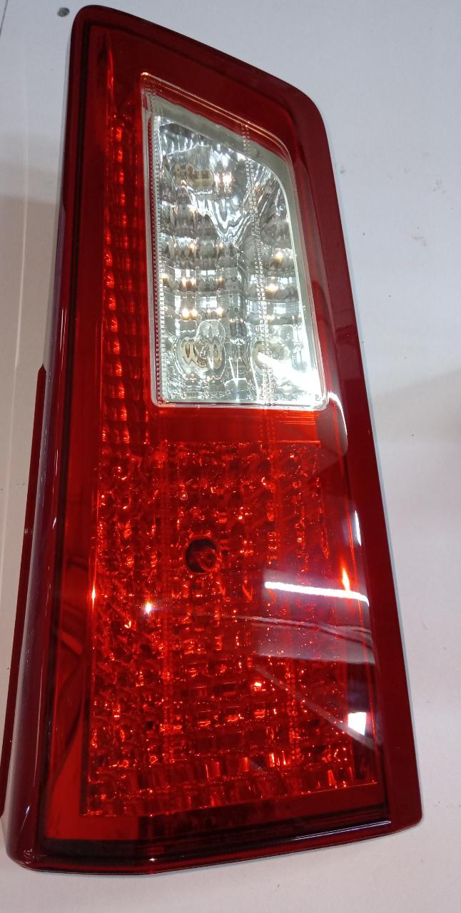 Toyota rear left lamp assembly for Toyota vehicles, model 815900K070, showing the lens and wiring in the image.